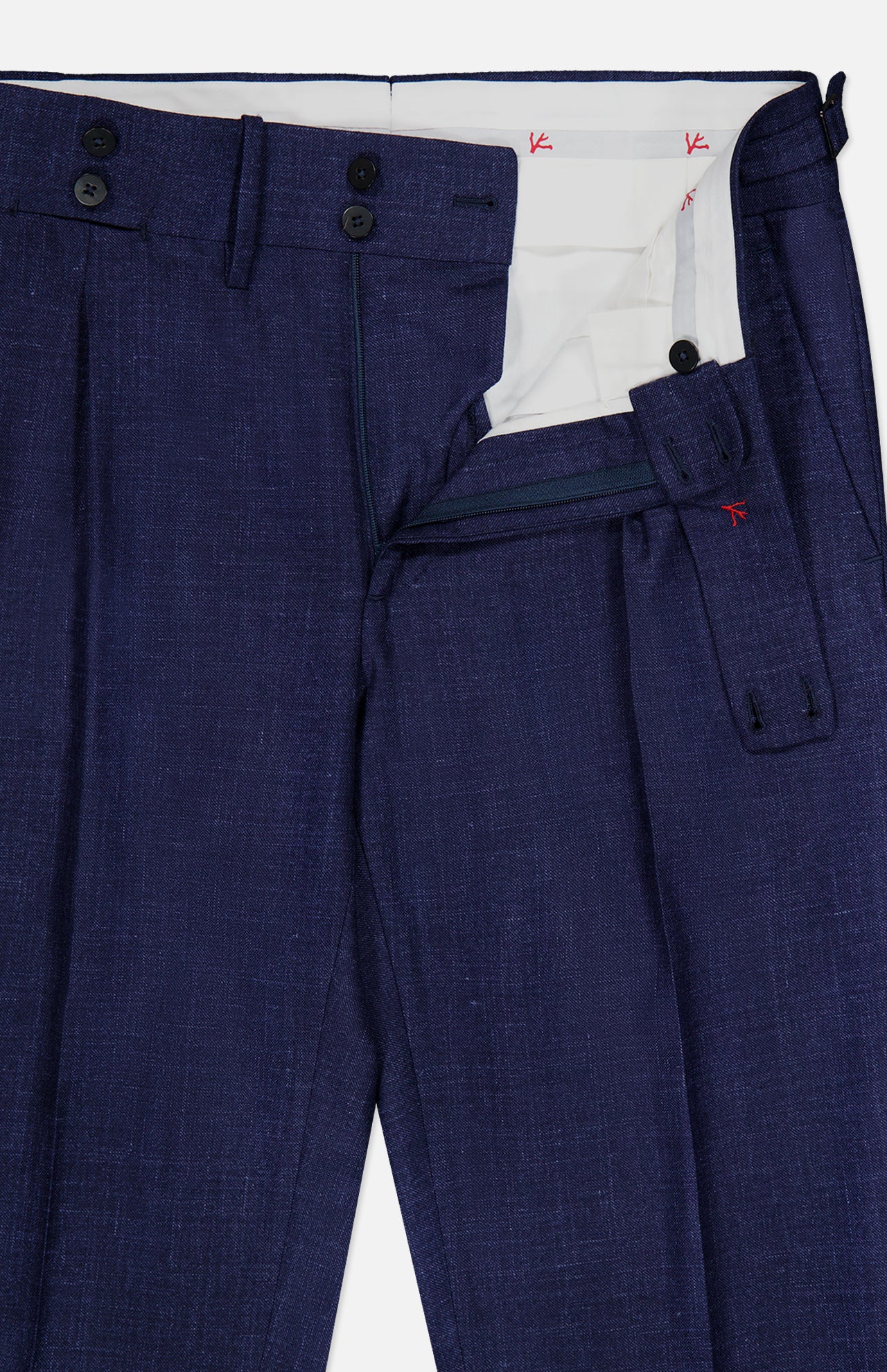 A close-up of the ISAIA Soft Delain Casalnuovo Trouser Pant in navy, featuring an open fly with black buttons, detailed waistband, and a white interior lining decorated with small red designs—embodying Neapolitan tradition and expert Italian craftsmanship.