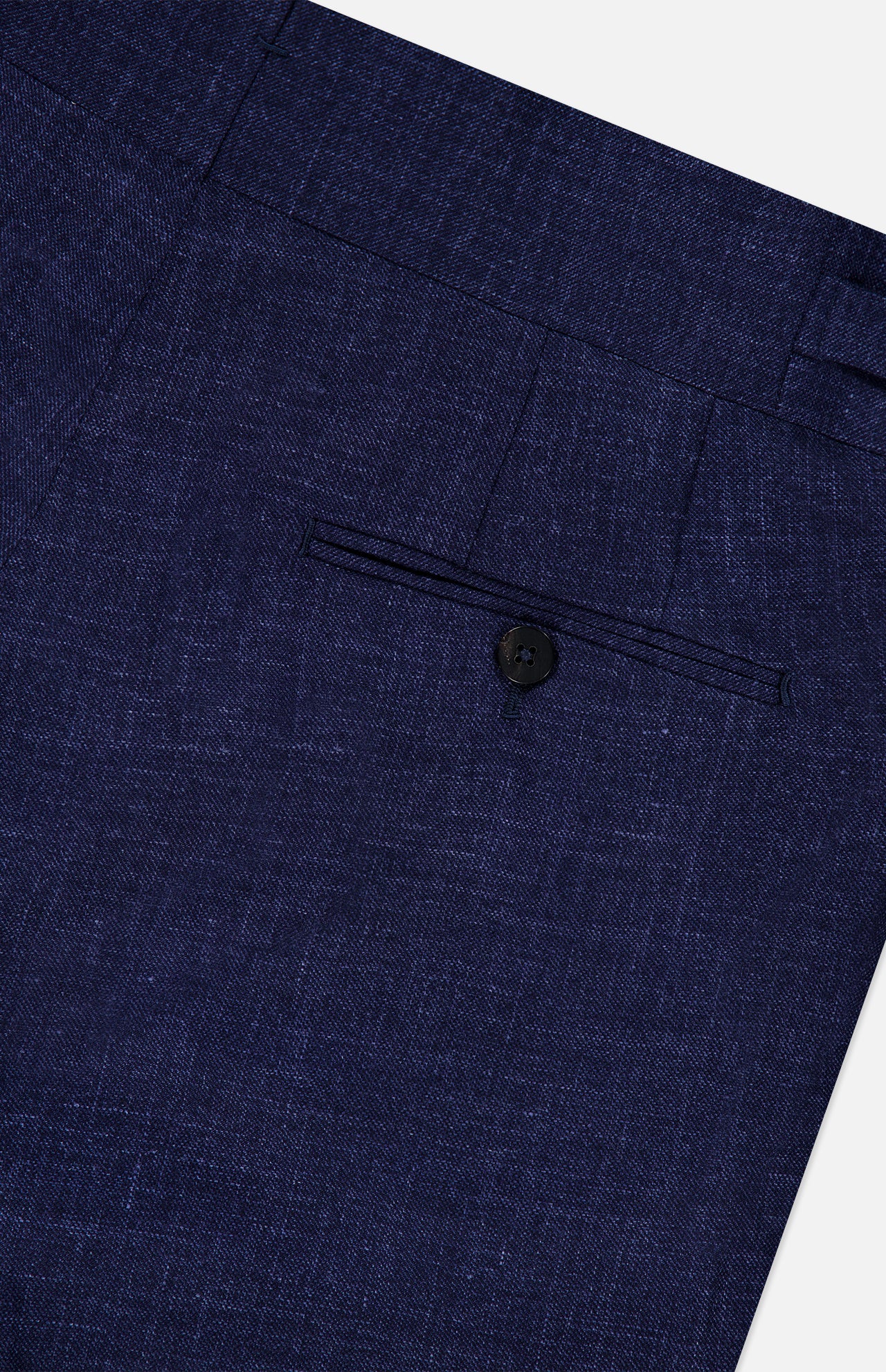 Close-up of the back pocket of the ISAIA Soft Delain Casalnuovo Trouser Pant, crafted from textured navy fabric and featuring a tailored seam with a single black button—a detail that reflects classic Neapolitan tradition and expert Made in Italy craftsmanship.