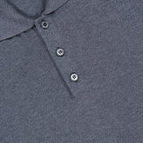 Close-up of the ISAIA Solid Silk Long Sleeve Polo Shirt in luxury grey, featuring a three-button placket and a classic collar, lying flat. A small part of a red tag is visible at the top left corner.