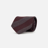 A rolled Isaia Stripe Tie in burgundy featuring wide diagonal stripes in dark red and grey.