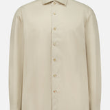 The ISAIA Tessuto Camicia Dress Shirt is a beige, long-sleeve button-up with a pointed collar and light buttons, displayed on a plain white background. Drawing inspiration from timeless Italian style, this classic shirt features a simple, elegant design.