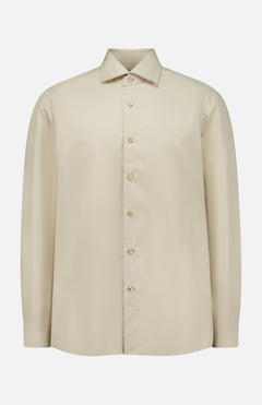 The ISAIA Tessuto Camicia Dress Shirt is a beige, long-sleeve button-up with a pointed collar and light buttons, displayed on a plain white background. Drawing inspiration from timeless Italian style, this classic shirt features a simple, elegant design.