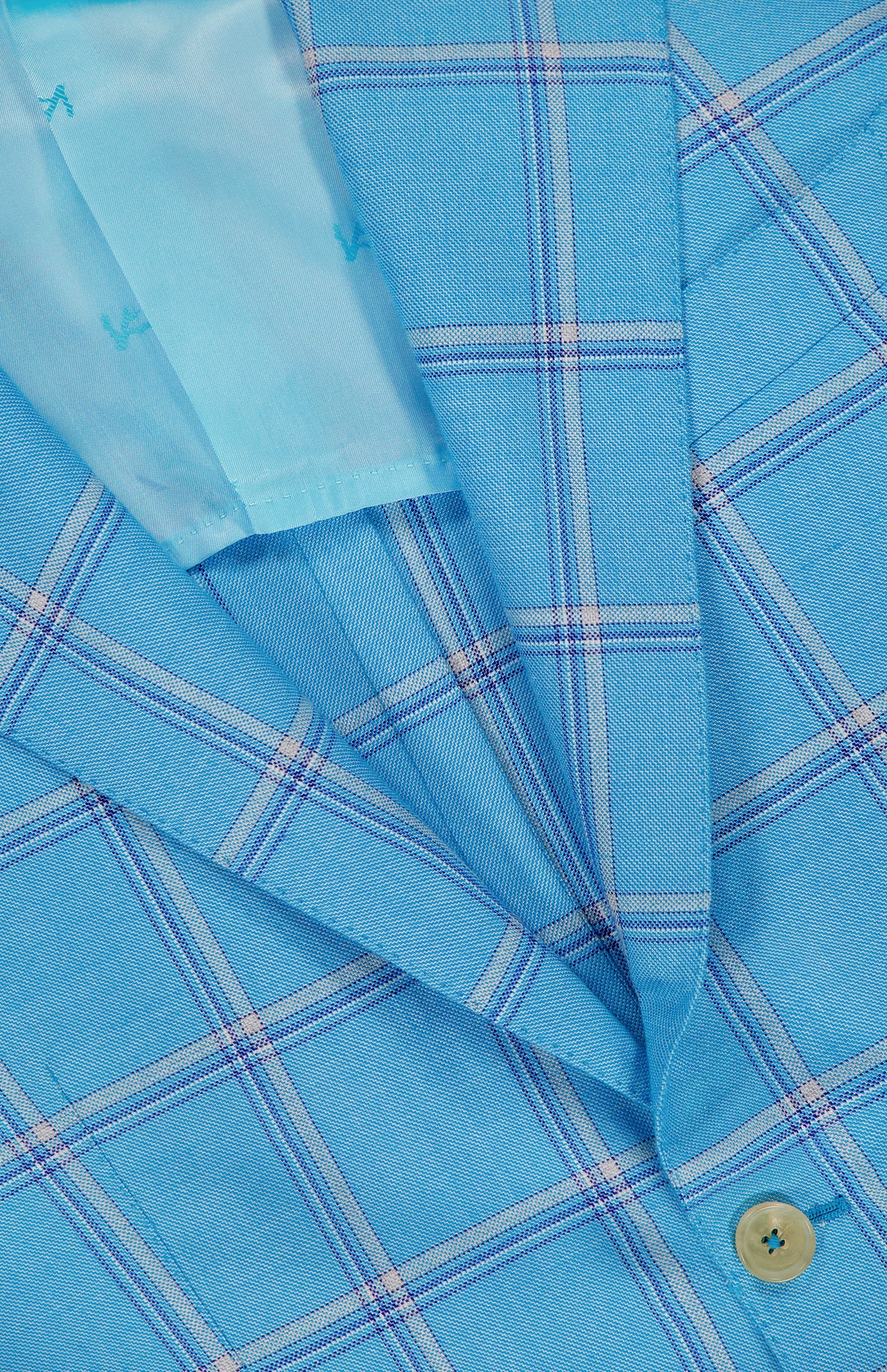 Close-up of the Over Check Top Cashsilk Sportcoat by ISAIA, a light blue plaid blazer with fine white and purple lines, detailed lapel, button, and visible inner lining. Crafted in Italy from smooth cashmere-silk blend fabric.