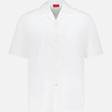 The ISAIA Seersucker Short Sleeve Camp Shirt is a men's white cotton button-up with short sleeves, a collar, and a small red tag by the hem, shown against a plain white background.