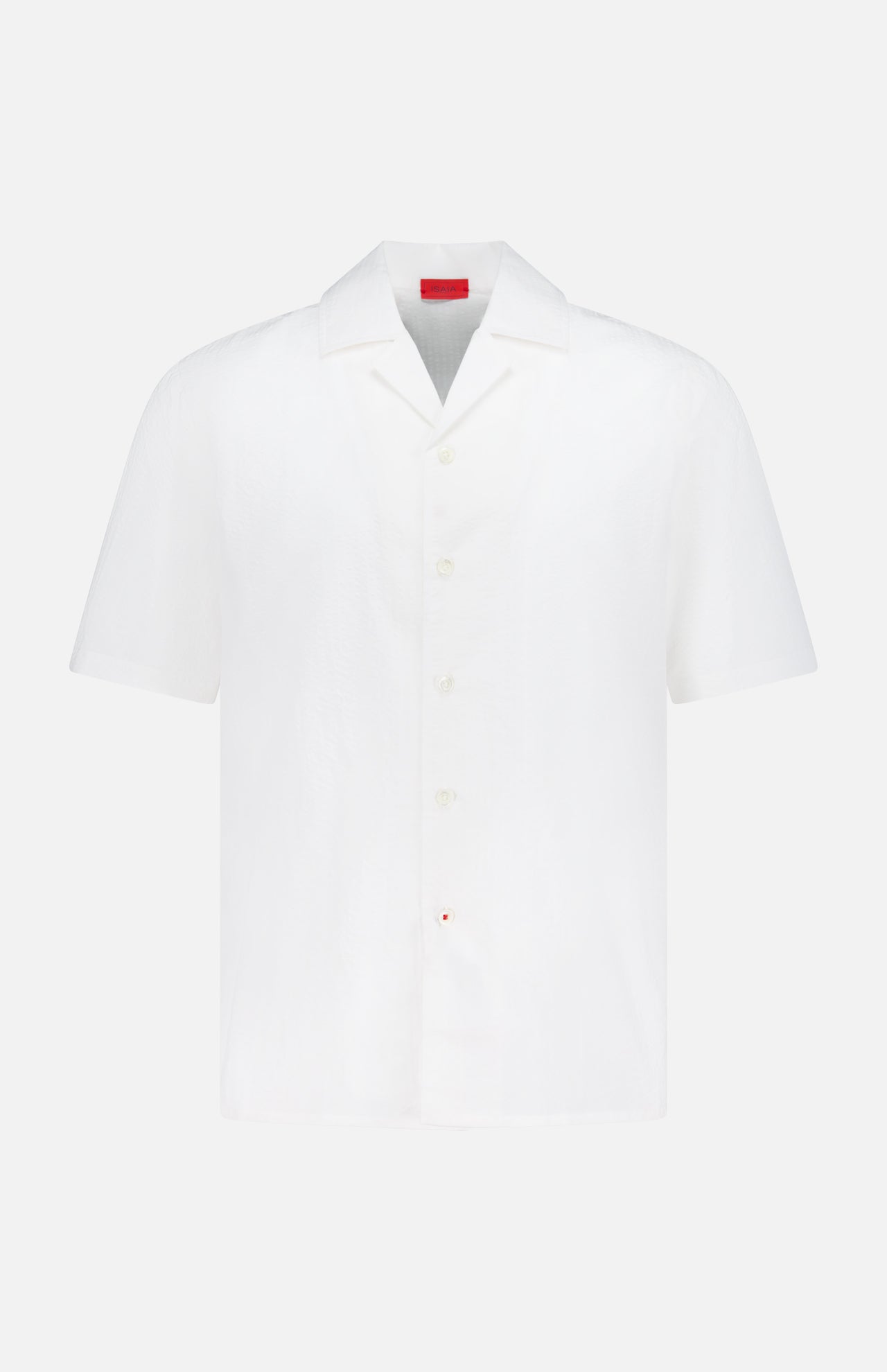 The ISAIA Seersucker Short Sleeve Camp Shirt is a men's white cotton button-up with short sleeves, a collar, and a small red tag by the hem, shown against a plain white background.