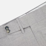Close-up of ISAIA Adjustable Tab Wool Trouser Pant in light gray, featuring a waistband with two dark buttons, belt loop, and front pocket—classic men's trousers ideal for any occasion.