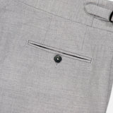 Close-up of the back pocket on ISAIA's Adjustable Tab Wool Trouser Pant in light gray, showing a single welt pocket with a black button and a visible belt loop on the waistband.