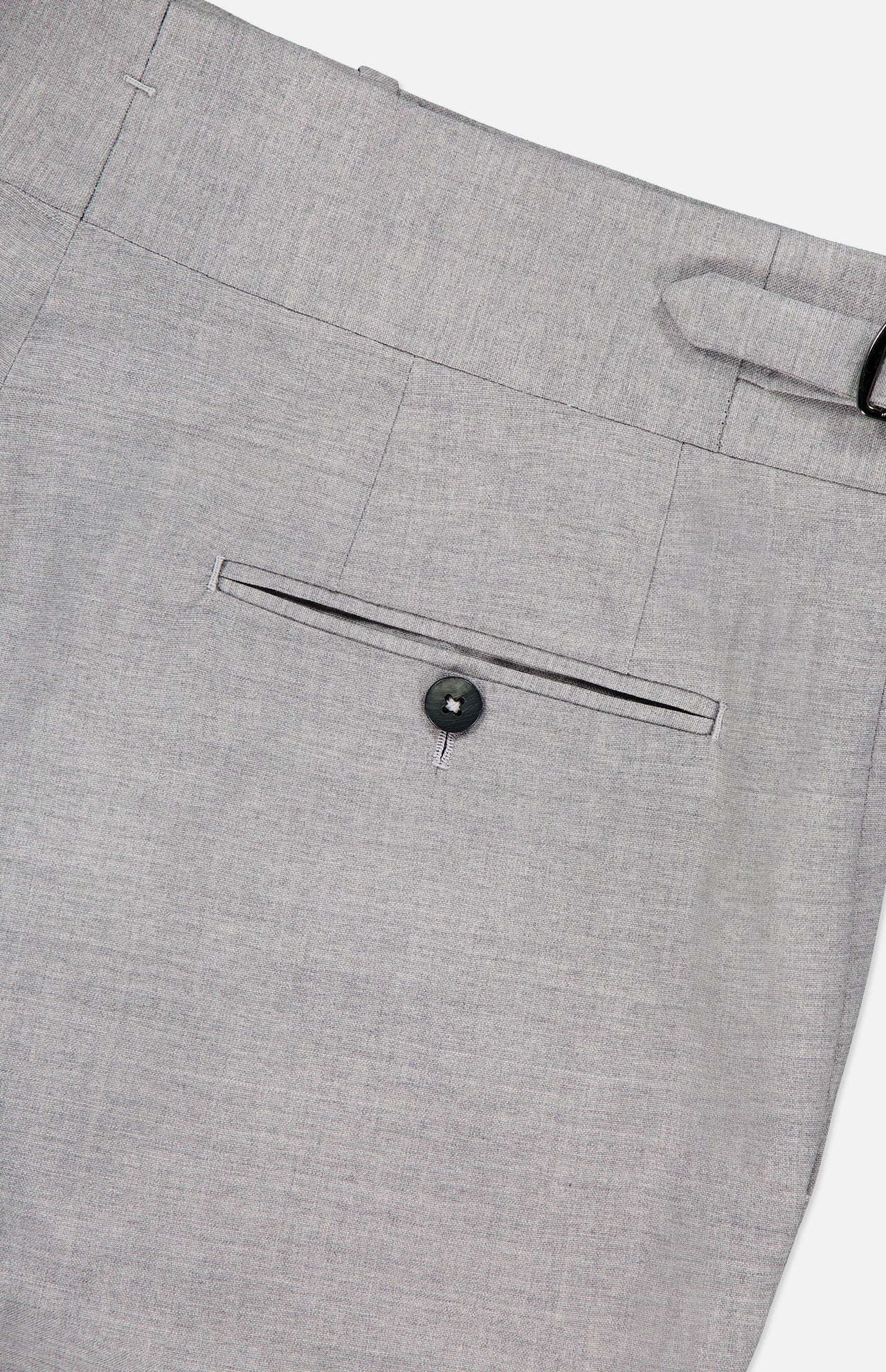 Close-up of the back pocket on ISAIA's Adjustable Tab Wool Trouser Pant in light gray, showing a single welt pocket with a black button and a visible belt loop on the waistband.