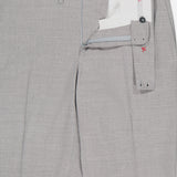 The ISAIA Adjustable Tab Wool Trouser Pant for men features light gray wool, a partially open fly and waistband revealing a white lining with red stitching, button closure, belt loops, side tabs for adjustment, and a tailored formal look.