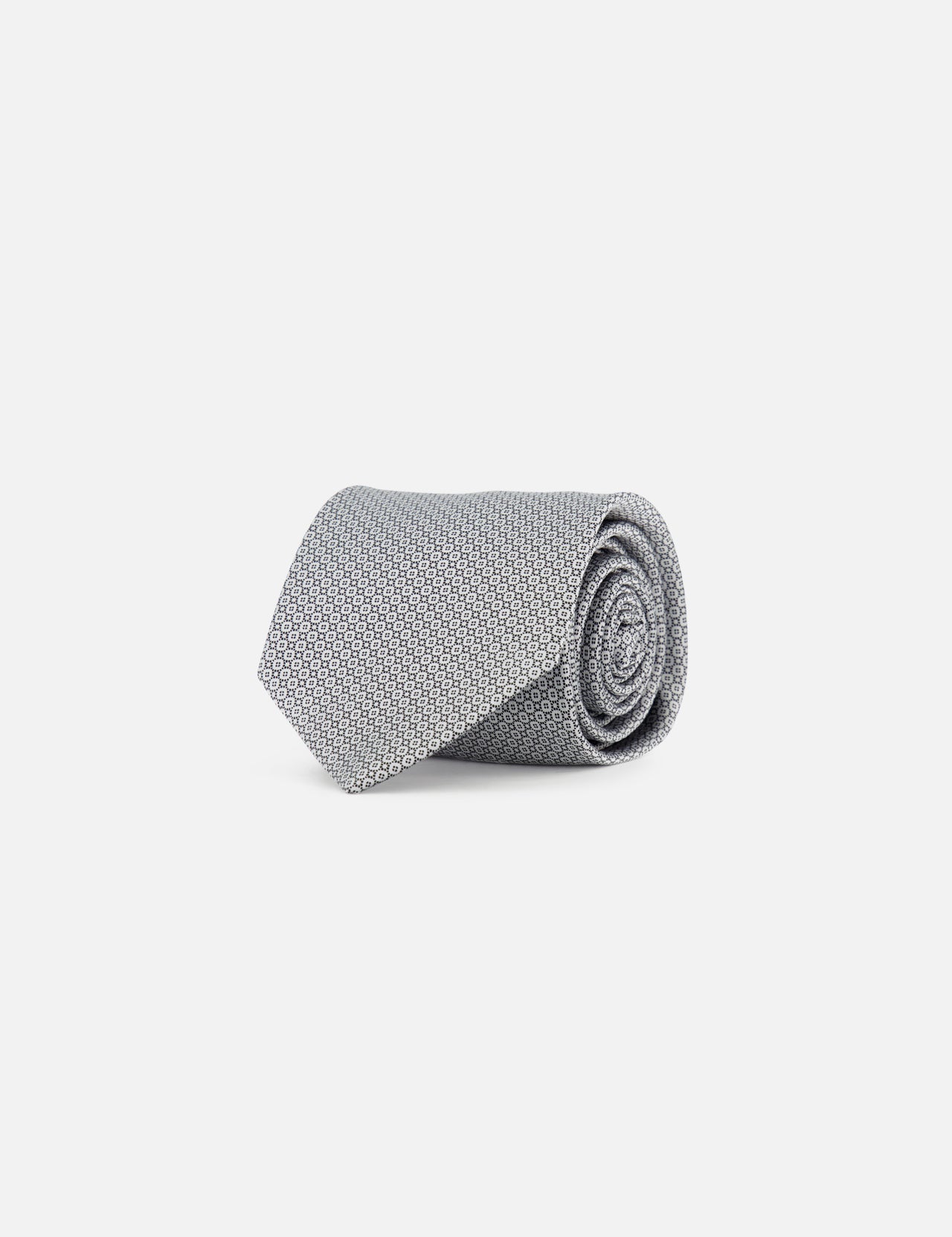 The ITALO FERRETTI Geometric Pattern Neck Tie, handmade in Italy, features a gray textured design and is neatly rolled on a plain white background.