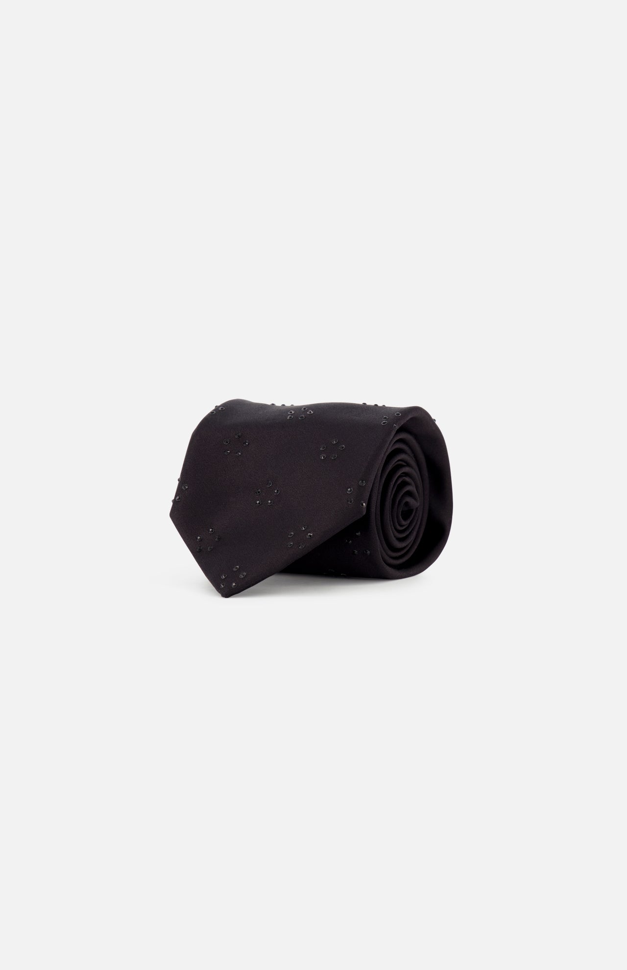 The ITALO FERRETTI Tonal Jeweled Neck Tie, handmade in Italy, features a subtle small dotted pattern on black silk and is shown rolled up on a plain white background.
