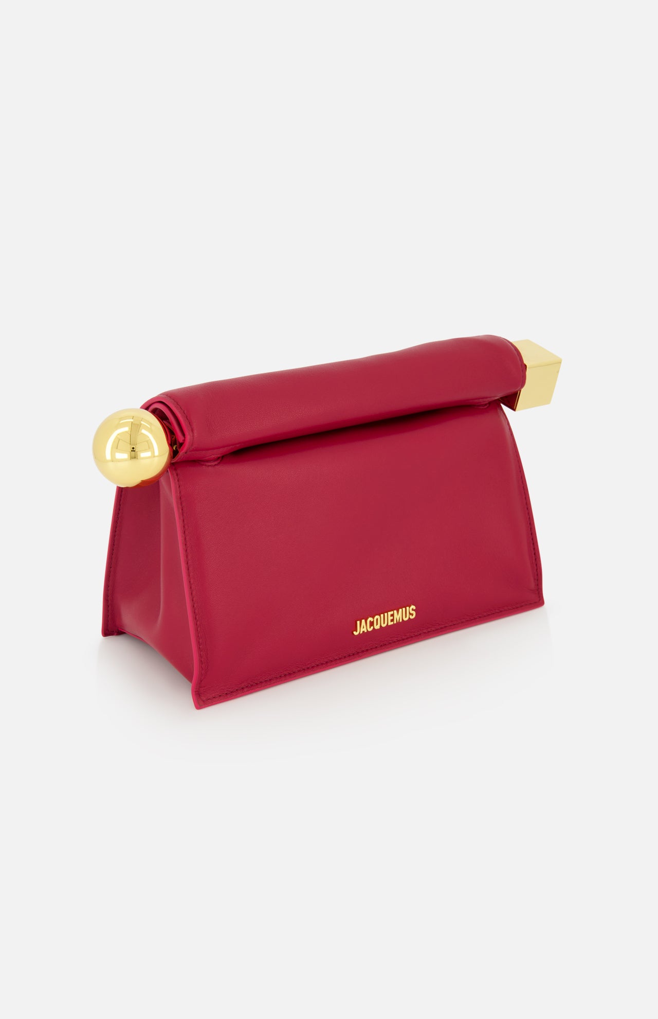 The JACQUEMUS La Pochette Rond Carre Clutch is a red, structured trapezoid bag with gold hardware on the corners and the brand's gold name on the front, embodying classic French elegance against a plain white background.