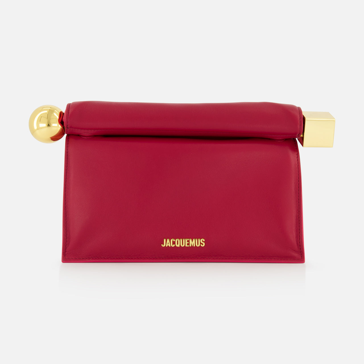 The JACQUEMUS La Pochette Rond Carre Clutch is a rectangular, deep pink French-style bag featuring a fold-over top, gold hardware at both ends, and JACQUEMUS in gold on the front—a bold designer statement for any event.