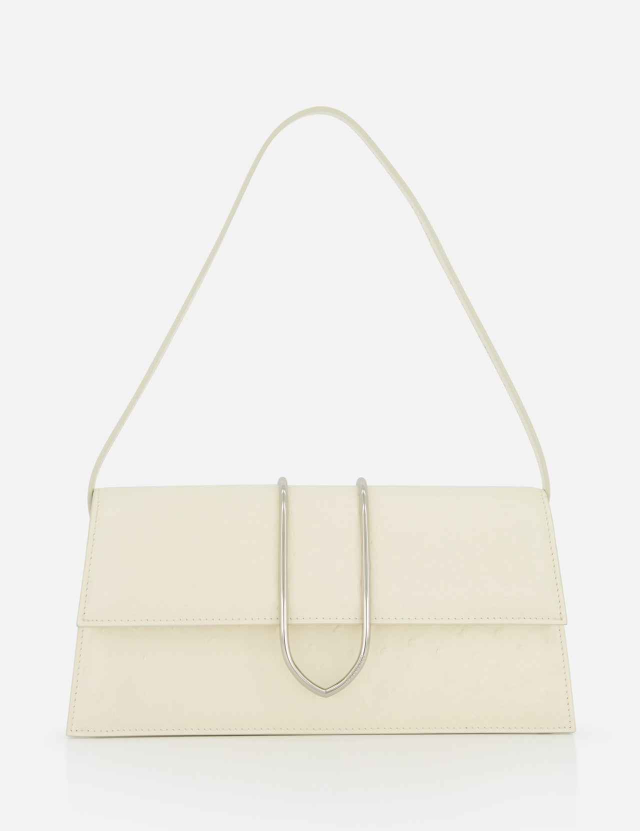 The JACQUEMUS Le Bambino Long Ostrich Bag is a minimalist off-white Italian leather top-handle bag, featuring a rectangular silhouette, ostrich embossed finish, single strap, and metallic U-shaped front detail against a plain white background.