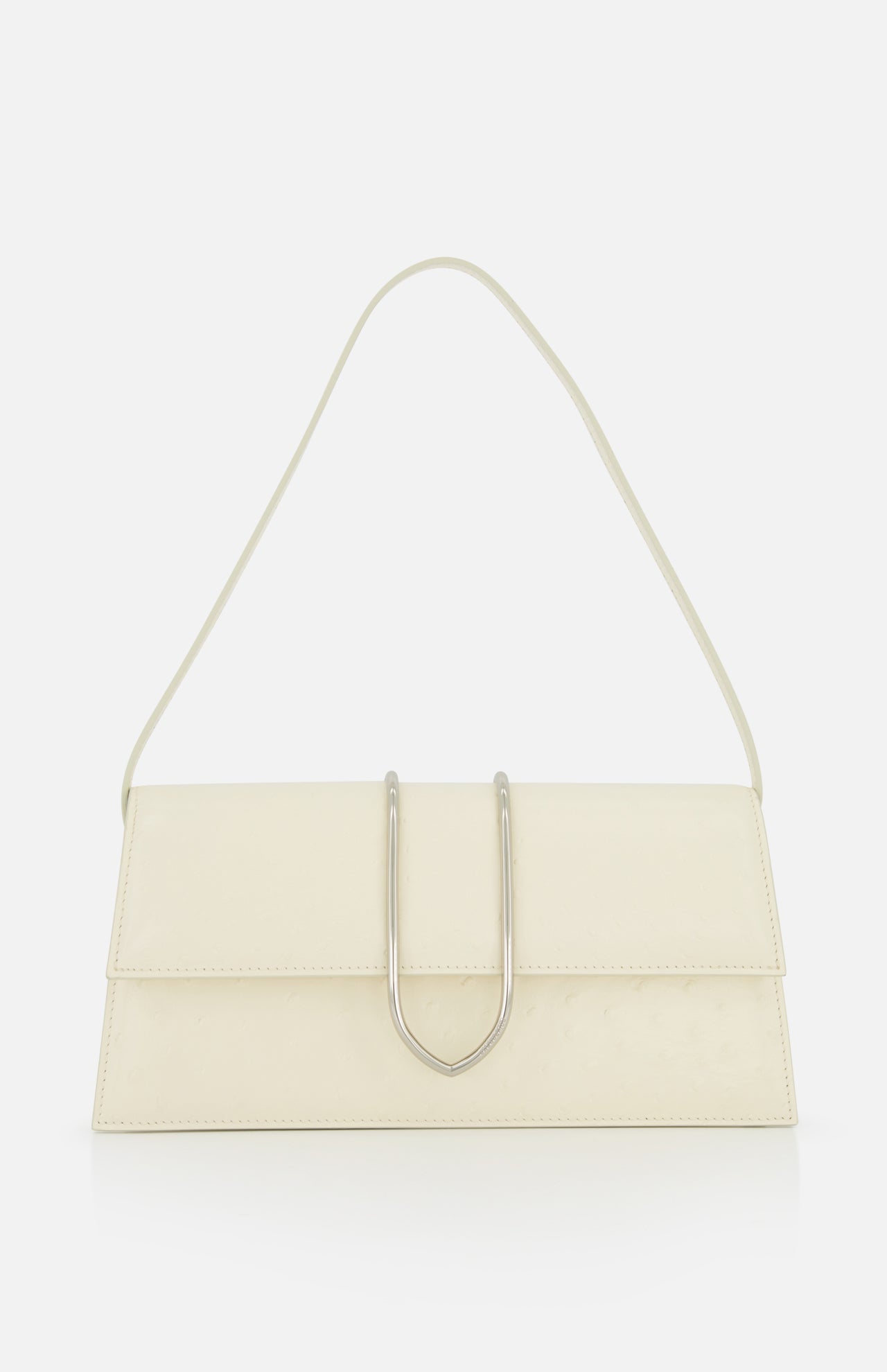 The JACQUEMUS Le Bambino Long Ostrich Bag is a minimalist off-white Italian leather top-handle bag, featuring a rectangular silhouette, ostrich embossed finish, single strap, and metallic U-shaped front detail against a plain white background.