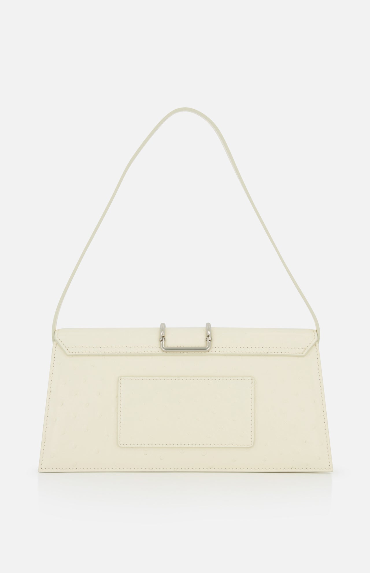The JACQUEMUS Le Bambino Long Ostrich Bag features a cream ostrich-embossed finish, a single slim shoulder strap, front pocket, and metallic top clasp. Its minimalist design and subtle texture make a striking statement.