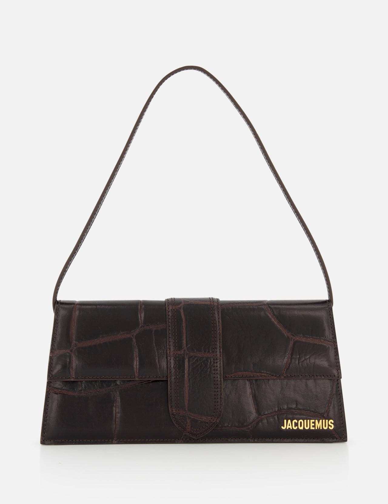 A rectangular, dark brown Le Bambino Long Croco-effect Shoulder Bag by JACQUEMUS with a single short strap and gold logo in the bottom right corner, set against a plain white background.