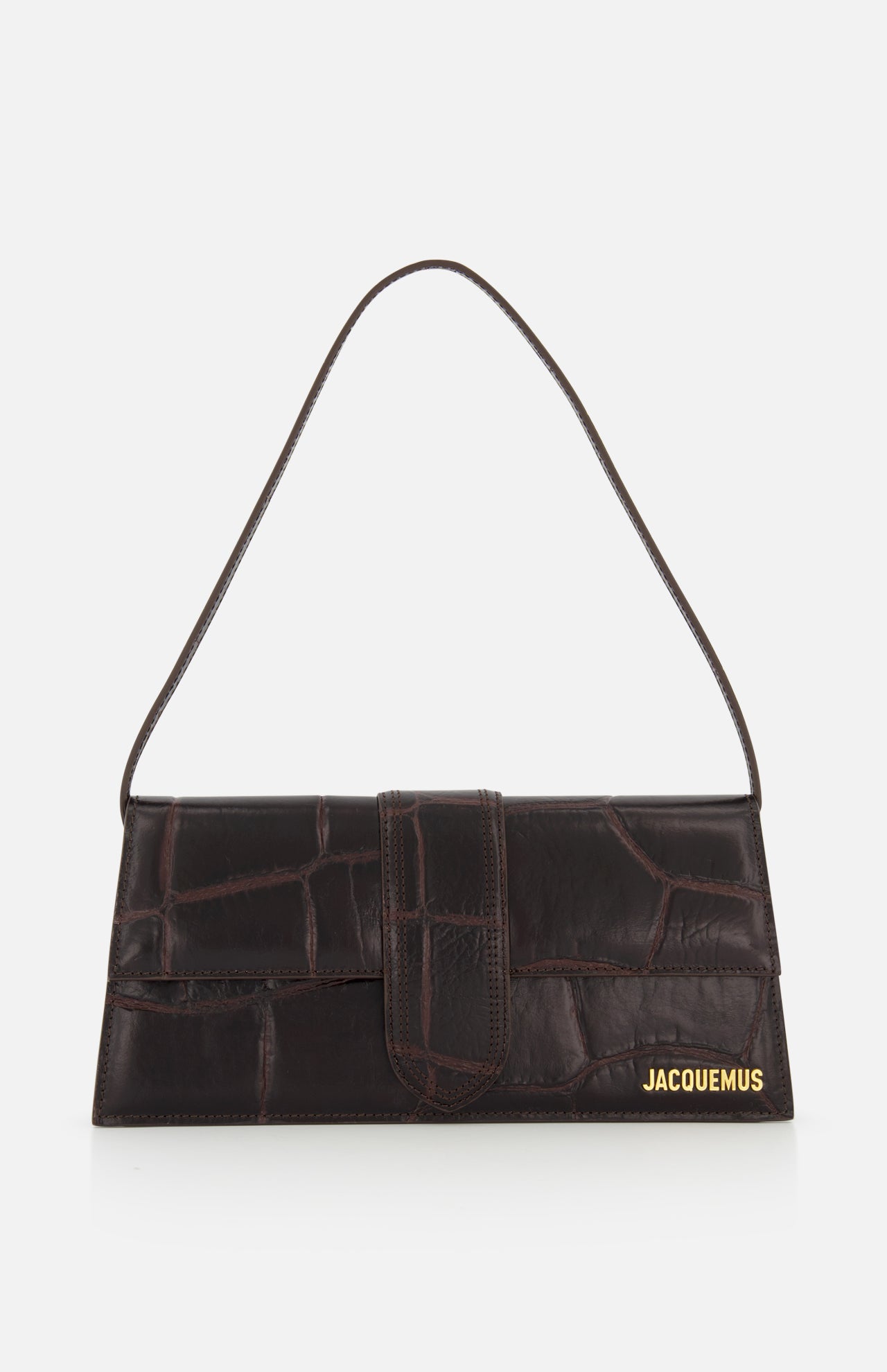 A rectangular, dark brown Le Bambino Long Croco-effect Shoulder Bag by JACQUEMUS with a single short strap and gold logo in the bottom right corner, set against a plain white background.