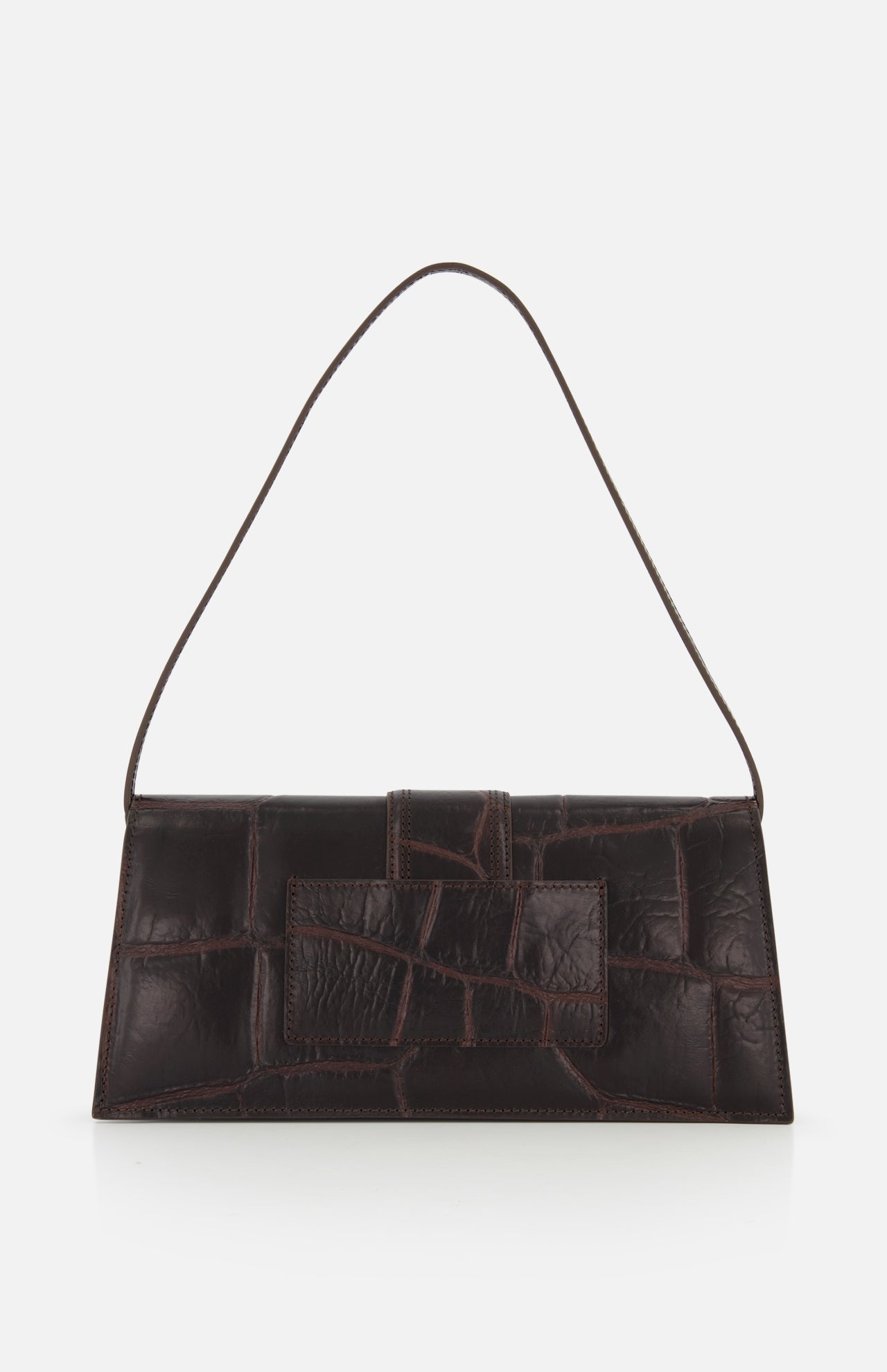 The JACQUEMUS Le Bambino Long Croco-effect Shoulder Bag is a rectangular, dark brown leather bag with a textured finish and adjustable strap, shown against a plain white background.