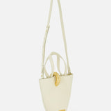 The JACQUEMUS Le Petit Bambola Tote Bag is an ivory leather bucket bag with a structured shape, gold hardware, an adjustable shoulder strap, front gold accent, and JACQUEMUS branding—bringing elegance to any look.