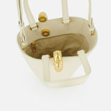 The JACQUEMUS Le Petit Bambola Tote Bag in cream ivory leather features gold hardware, a tan interior lining, an inner zip pocket, and a front gold clasp. Shown open from above.