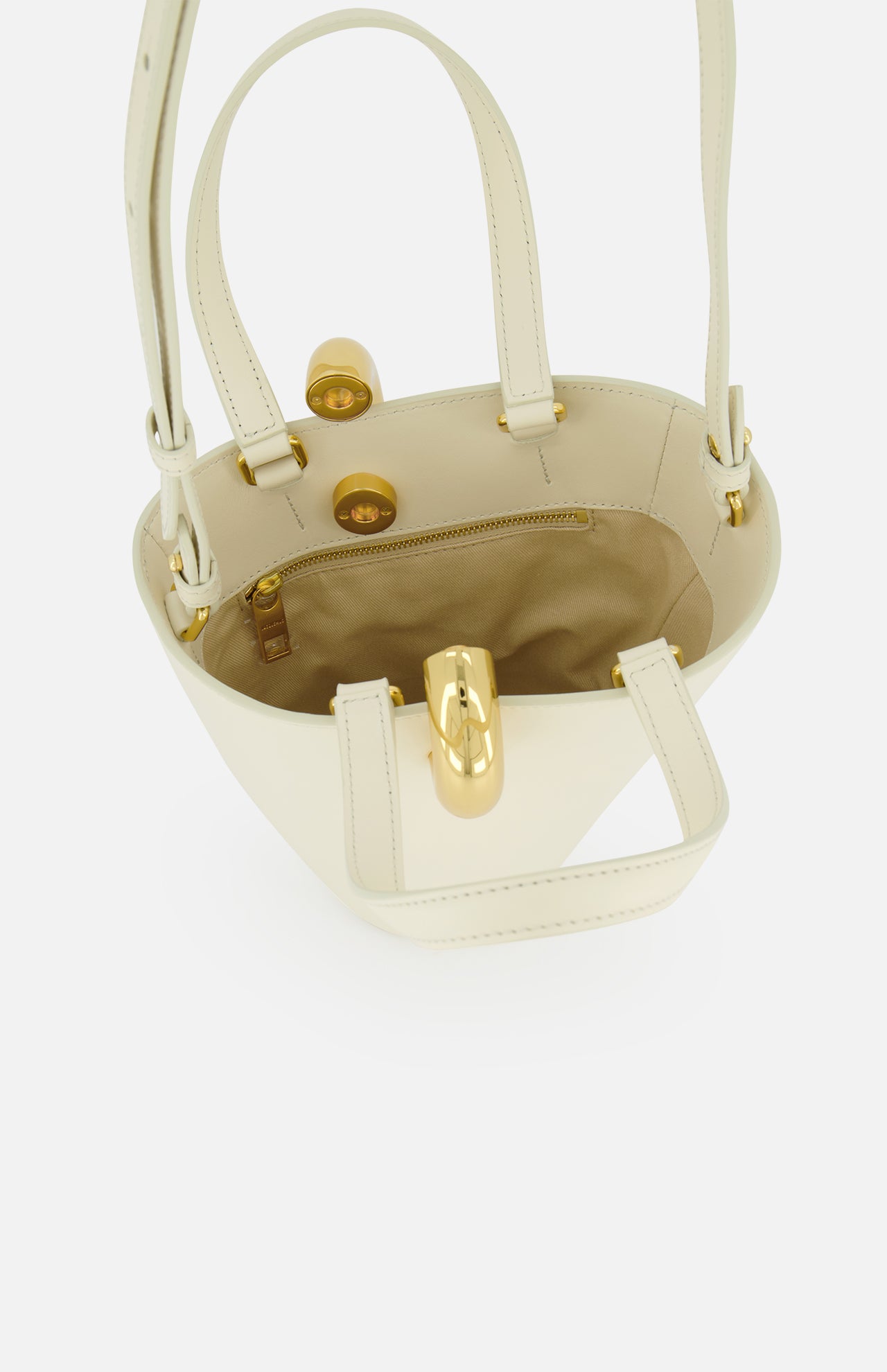 The JACQUEMUS Le Petit Bambola Tote Bag in cream ivory leather features gold hardware, a tan interior lining, an inner zip pocket, and a front gold clasp. Shown open from above.
