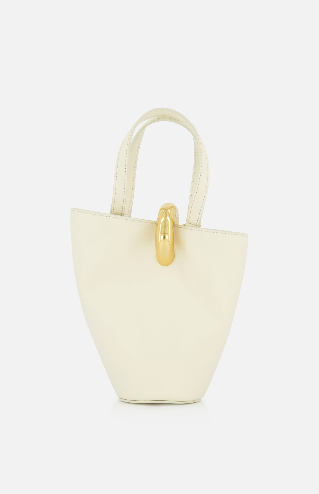 The JACQUEMUS Le Petit Bambola Tote Bag, crafted in cream leather with two handles and a gold front clasp, is displayed against a plain white background.