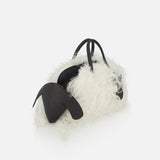 JACQUEMUS Le Petit Turismo Sheep Hand Bag in white shearling with black leather handles and animal-like ear accents.