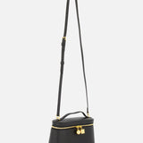 The Le Petit Vanity Bag by JACQUEMUS is a vintage-inspired crossbody crafted from black leather, featuring a sleek top handle, gold zipper, and an elegant gold padlock detail, shown against a plain white background.