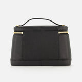 The Le Petit Vanity Bag by JACQUEMUS, crafted from black leather and featuring gold zippers with a sturdy top handle, is elegantly displayed against a white background.