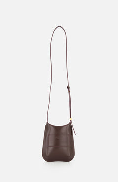 The JACQUEMUS Le Porte Telephone Bisou Bag is a small brown leather crossbody made in Italy, with a long adjustable strap and a front pocket, shown against a plain white background.