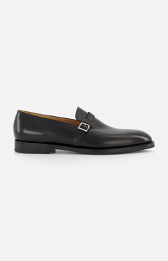 The Delano II Oxford Loafer by JOHN LOBB, shown in side profile against a white background, features black leather and an eye-catching buckle detail in a classic monk strap style.