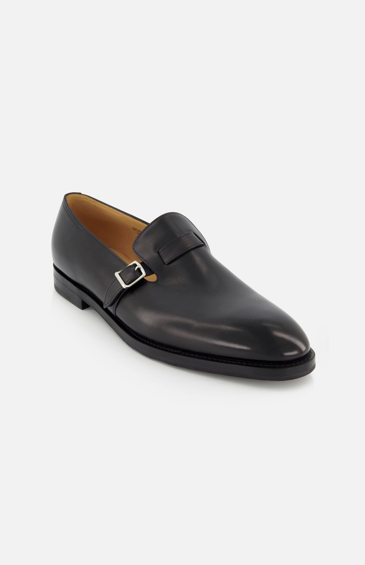 The JOHN LOBB Delano II Oxford Loafer is a single black leather dress shoe with a low heel, sleek buckle detail, and smooth polished finish, showcased on a plain white background.