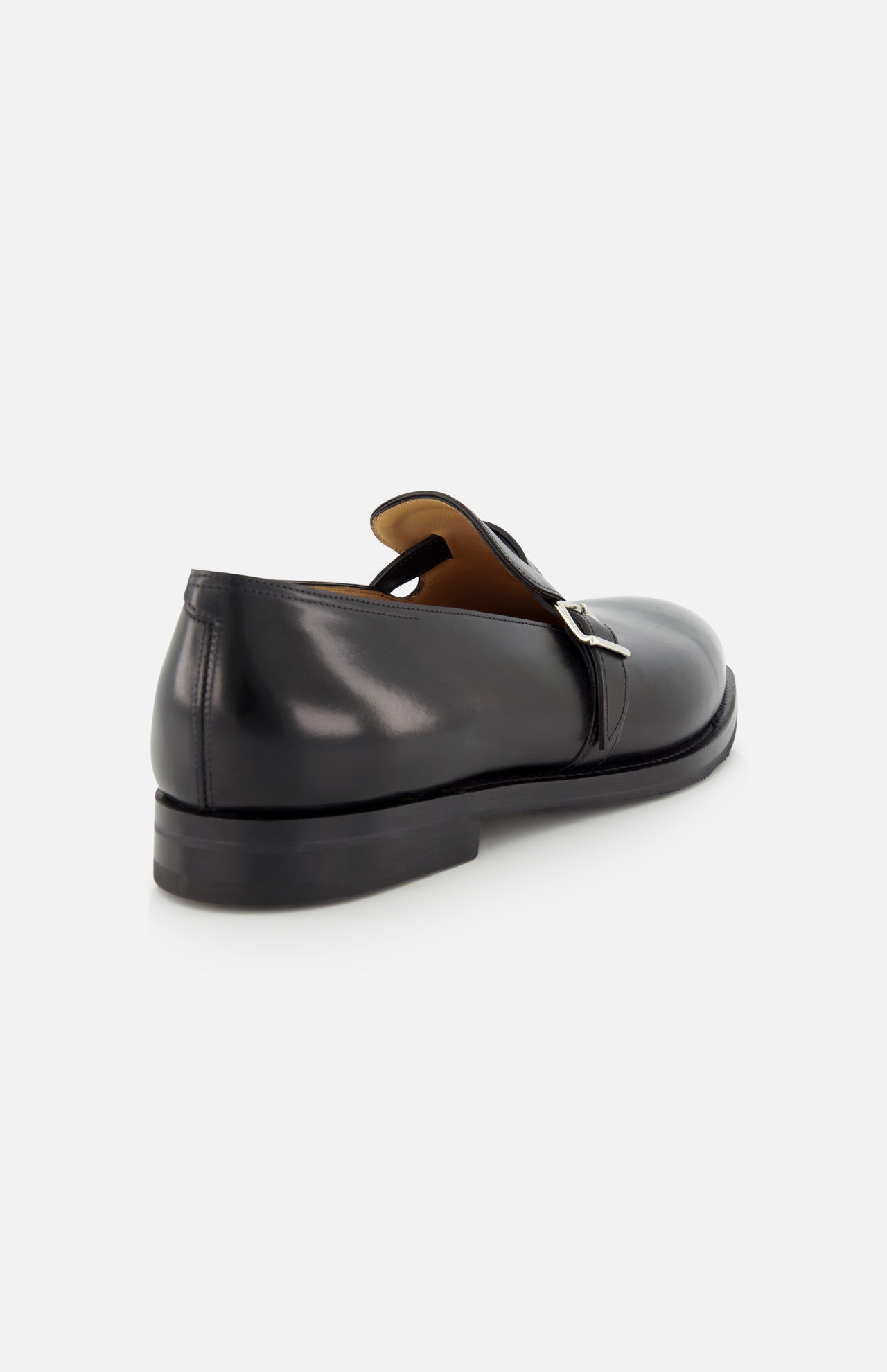 The JOHN LOBB Delano II Oxford Loafer in black leather features a single silver buckle, smooth finish, and low heel, shown from the back and side against a light background.