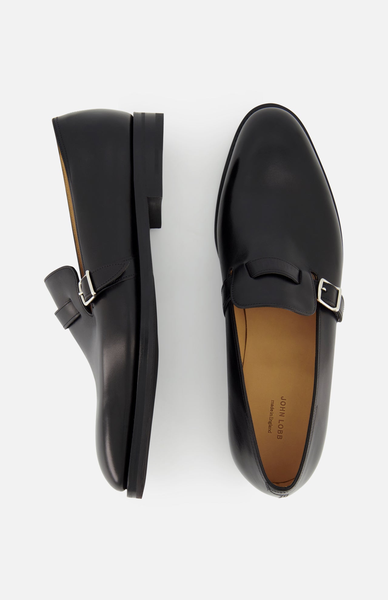 The JOHN LOBB Delano II Oxford Loafer, crafted in black leather with buckle detail, is displayed from the side and top views against a plain white background.
