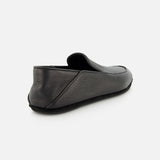 A rear view of the black JOHN LOBB Kingston II Loafer highlights its textured surface and low heel against a plain white background.