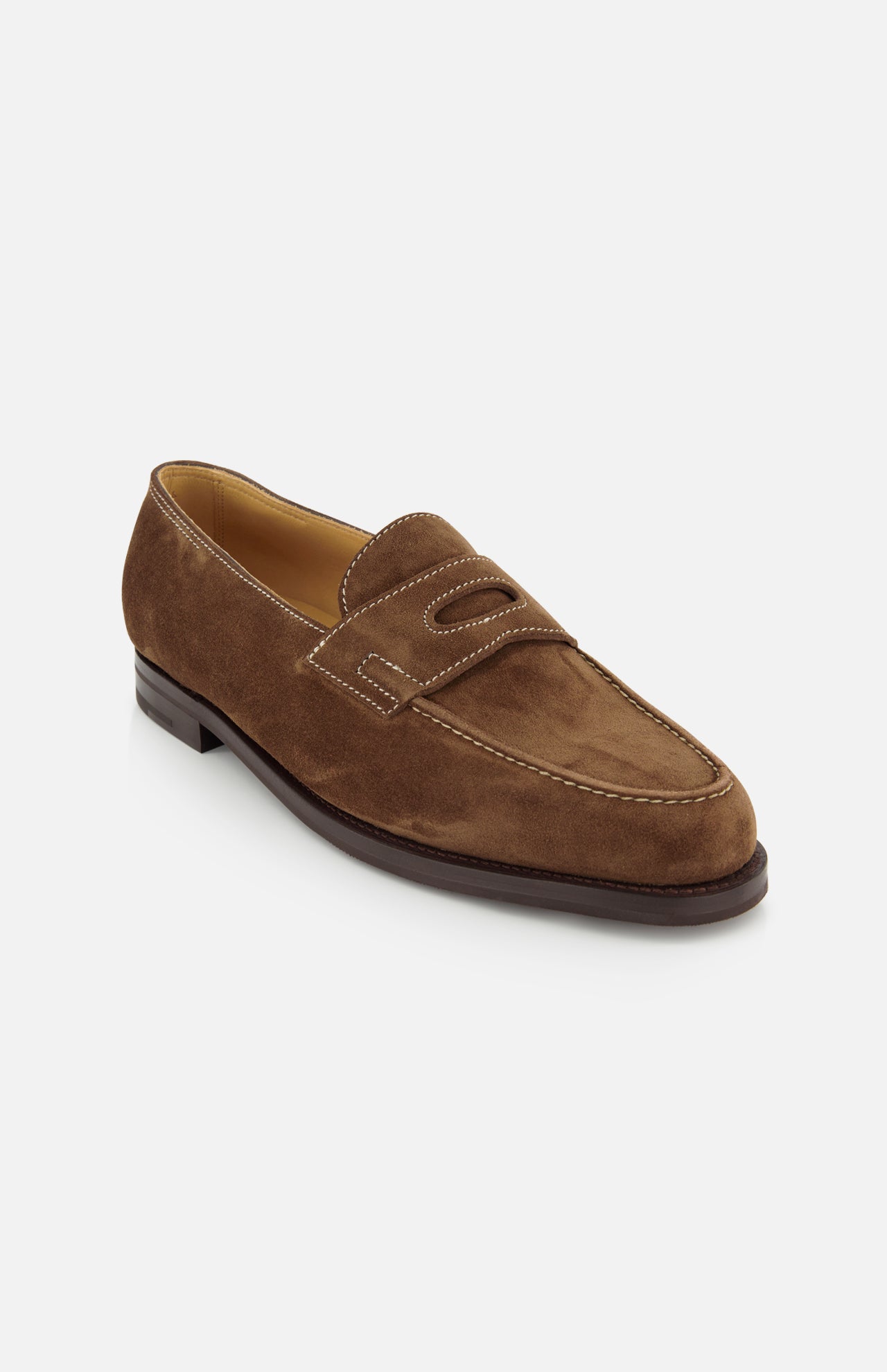 The JOHN LOBB Lopez Suede Loafer is a classic dark brown suede loafer, handmade in England with white stitching, a rounded toe, low heel, and decorative cutout on the upper, shown against a plain white background.