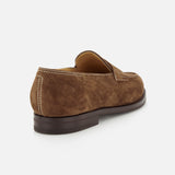 The JOHN LOBB Lopez Suede Loafer, shown from a rear side angle against a white background, is handmade in England with dark brown suede, white stitching, a low heel, and a smooth dark brown sole.