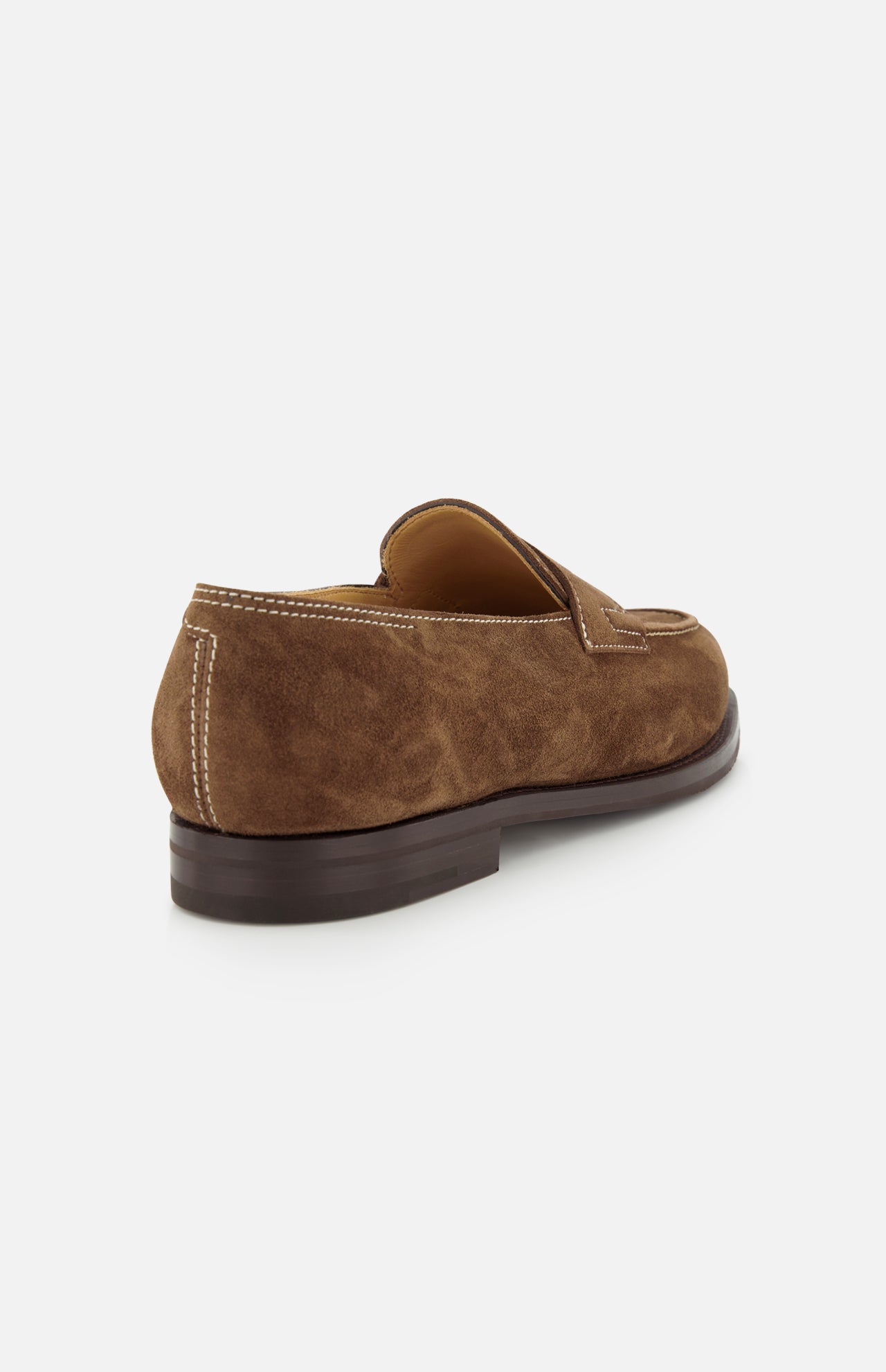 The JOHN LOBB Lopez Suede Loafer, shown from a rear side angle against a white background, is handmade in England with dark brown suede, white stitching, a low heel, and a smooth dark brown sole.