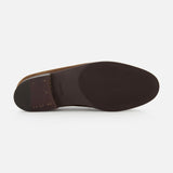 The image displays the bottom view of the JOHN LOBB Lopez Suede Loafer in dark brown, handmade in England. It features a smooth sole, a slightly raised heel with small gold-colored studs, set against a plain white background.