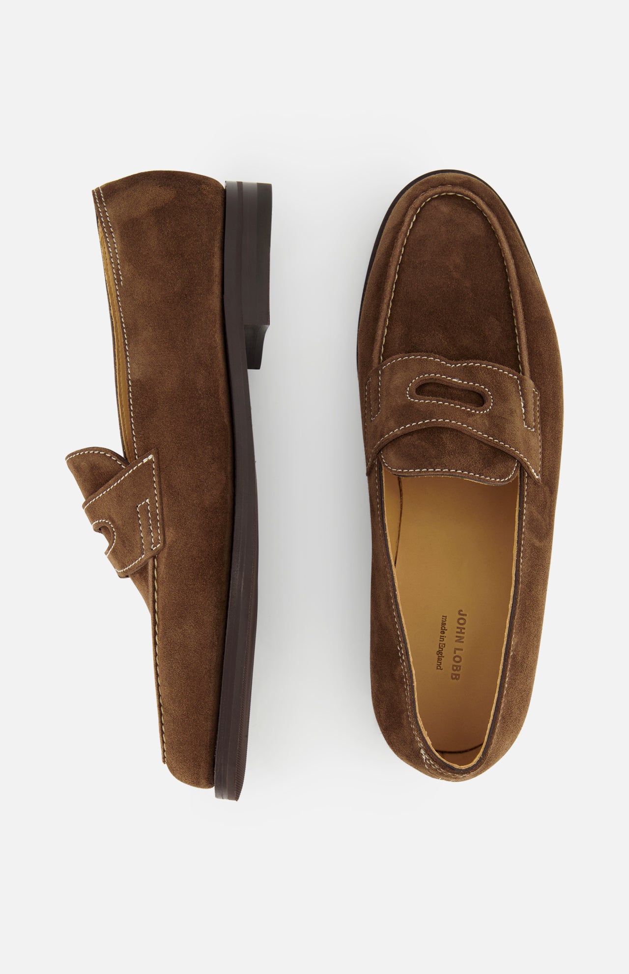 The JOHN LOBB Lopez Suede Loafer, in dark brown suede with visible stitching and classic design, is handmade in England. Shown are the left shoe (side view) and right shoe (top view), set against a plain white background.