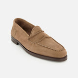 The Bath Nubuck Loafer by JOHN LOBB is a tan slip-on shoe featuring a moccasin toe, visible stitching, and a low dark brown sole. Displayed on a white background, this unlined loafer is inspired by classic handmade men’s styles and delivers effortless comfort and sophistication for everyday wear.