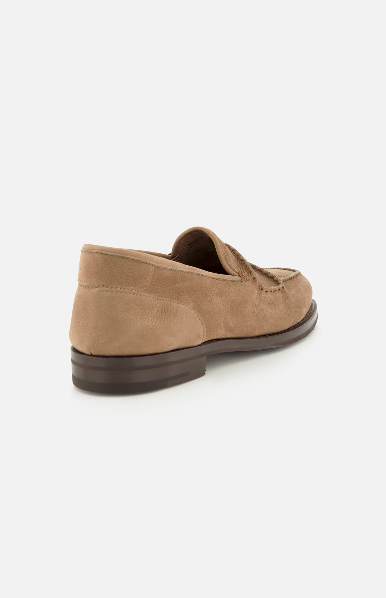 The Bath Nubuck Loafer by JOHN LOBB is showcased from the back and side on a plain white background, highlighting its tan nubuck upper, dark brown sole, and visible stitching. These handmade men’s loafers offer an unlined slip-on design focused on comfort and effortless style.