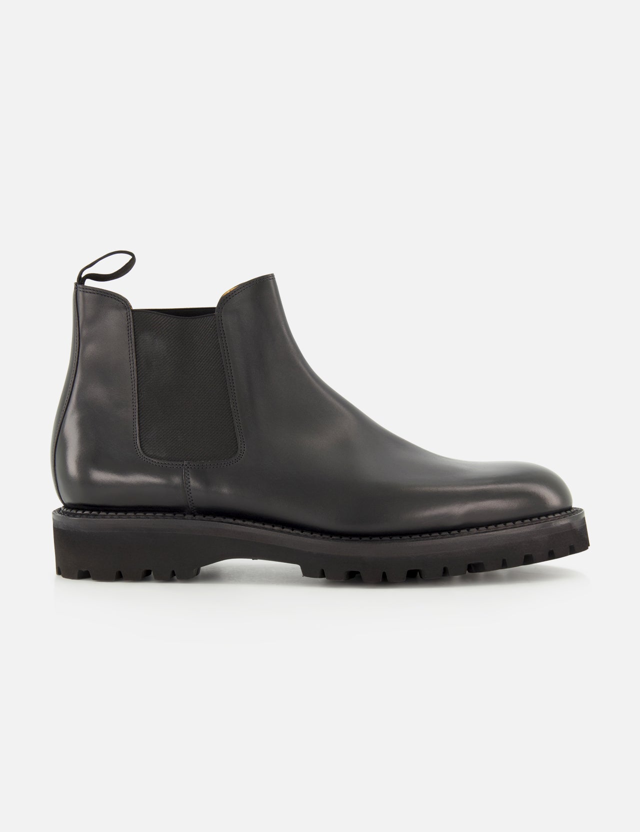 The Lawry Calfskin Boot by JOHN LOBB is a black leather Chelsea boot featuring a chunky treaded sole, elastic side panel, and rear pull tab in a slip-on style, displayed against a plain white background.