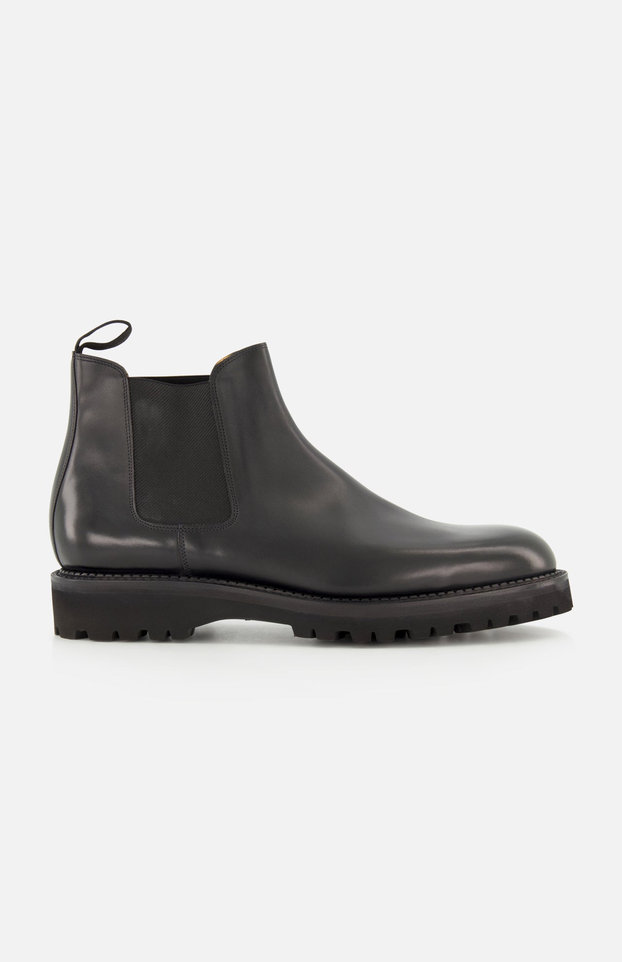The Lawry Calfskin Boot by JOHN LOBB is a black leather Chelsea boot featuring a chunky treaded sole, elastic side panel, and rear pull tab in a slip-on style, displayed against a plain white background.