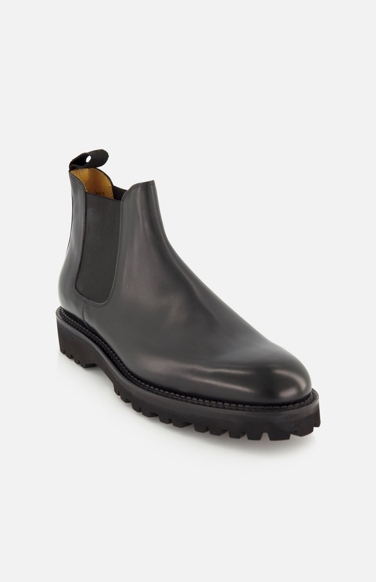The JOHN LOBB Lawry Calfskin Boot is displayed on a plain white background. This single black boot showcases a classic Chelsea slip-on style with elastic side panels, a pull tab at the back, and a thick, ridged sole.