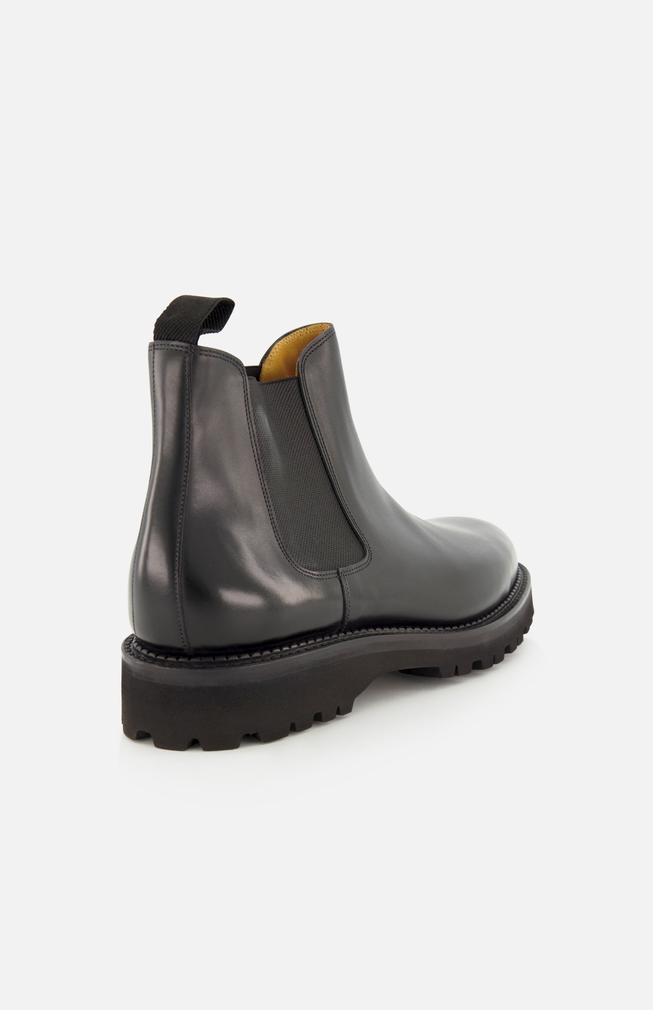 The Lawry Calfskin Boot by JOHN LOBB is a black leather Chelsea boot featuring a chunky sole, elastic side panel, and back pull tab, crafted in a classic slip-on style and displayed against a plain white background.