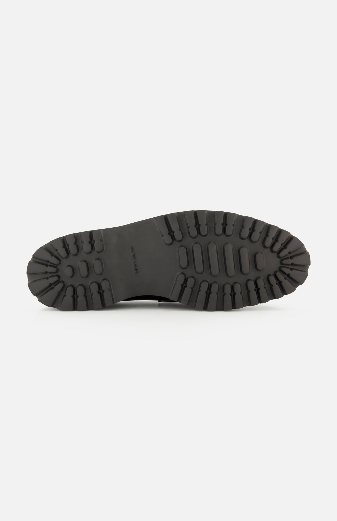 The image displays the black rubber sole of the JOHN LOBB Lopez Gentle Grain Loafer, featuring deep, chunky treads designed for superior grip and traction. Shown from the bottom, the entire length and intricate tread pattern are visible—an ideal foundation for this classic black leather loafer expertly handmade in England.