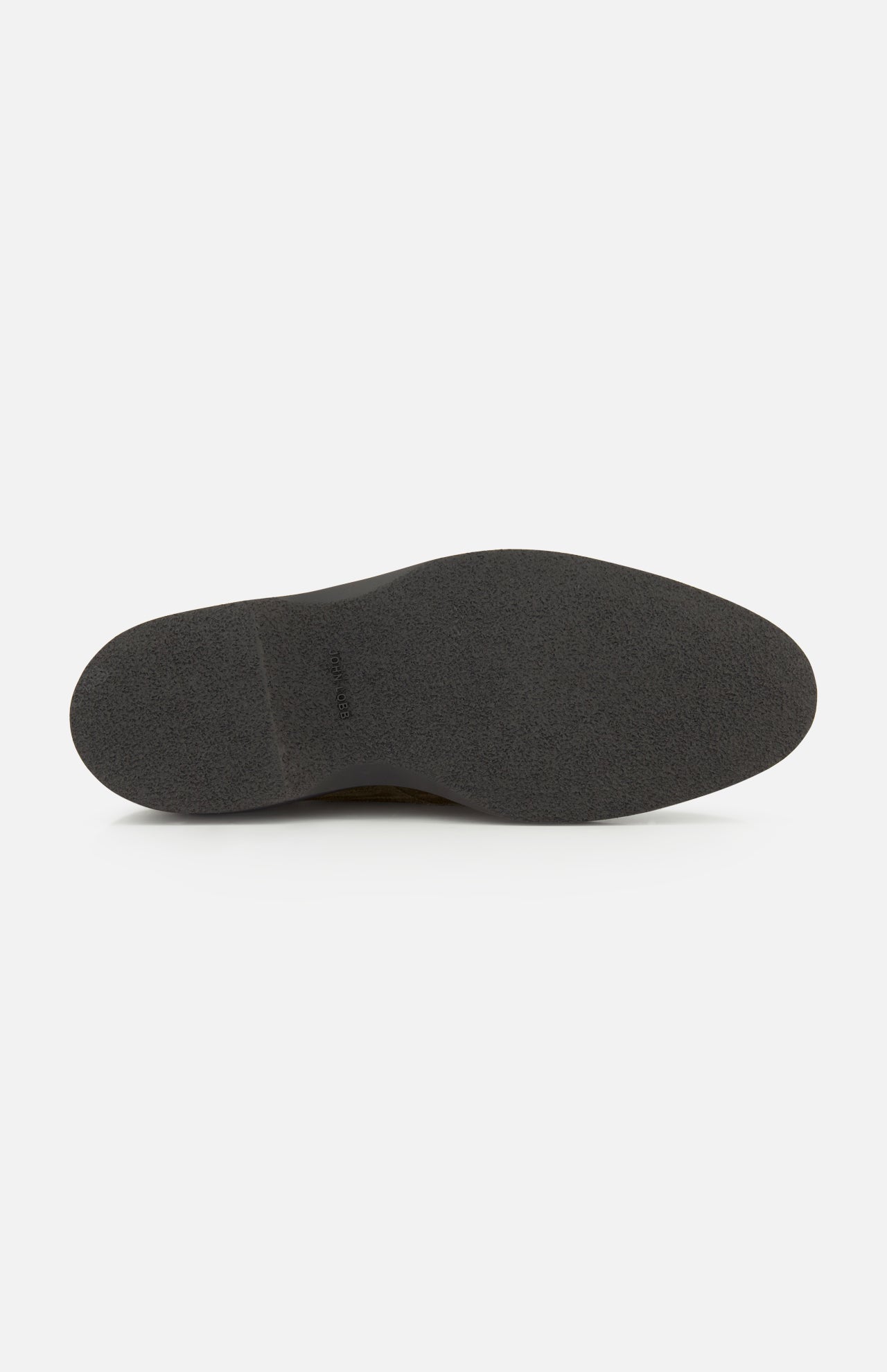 The image features the bottom view of the Smith Suede Loafer by JOHN LOBB—a single black shoe sole with a smooth, textured surface, photographed against a plain white background. This distinctive detail is characteristic of premium loafers made in England.