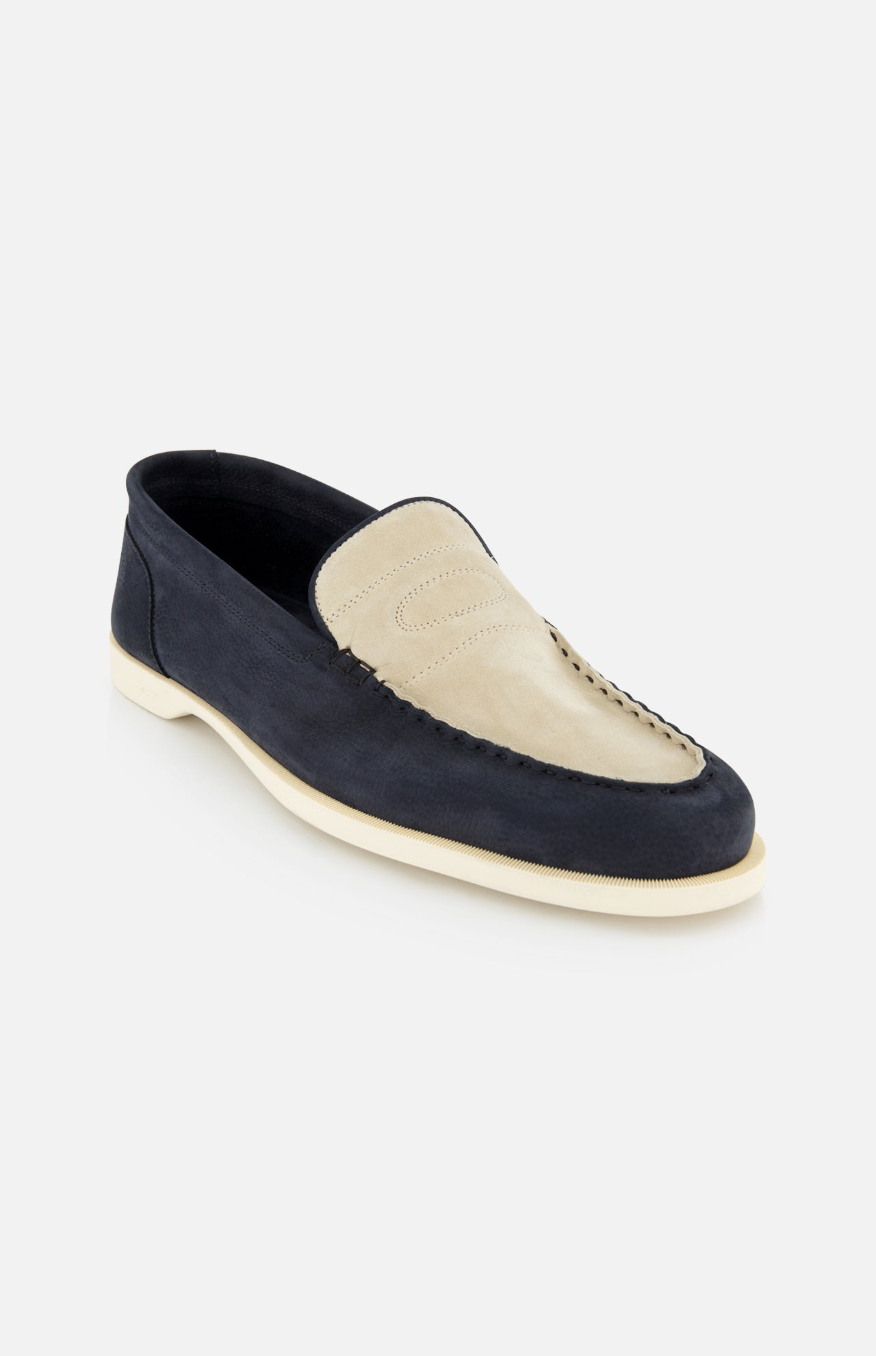 The JOHN LOBB Pace Suede 2 Tones Loafer features a beige suede upper, dark navy blue lower section, white stitching, and a white rubber super flex sole, shown on a light gray background.